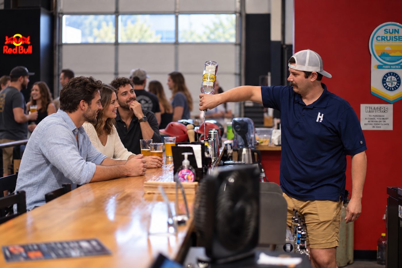 A Hitters team member pouring a draft beer for guests at the bar