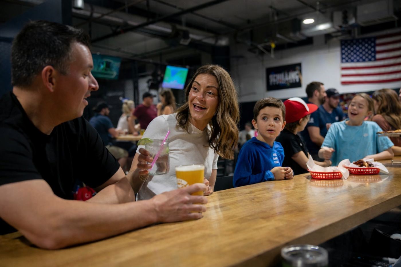 A family enjoying food and drinks together at Hitters